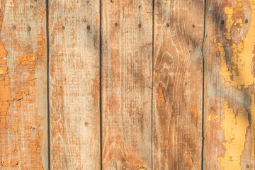 Old vintage planks wood texture, remnants of yellow paint weathered
