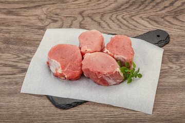 Raw pork medallion served rosemary