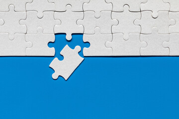 White jigsaw puzzle pieces. Fill in pieces of the jigsaw puzzle. Complete the jigsaw puzzle with...