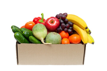 Fresh vegetables and fruits in a cardboard box on a white background