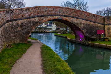 A view through the Rainbow bridge towards the lower canal basin at Foxton Locks, UK on a still winter's afternoon