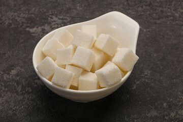 Refined white sugar cubs in the bowl