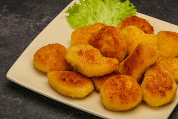 Fried chicken nuggets served salad leaves