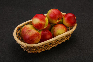 Sweet small nectarines in the basket