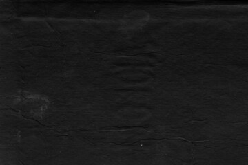 Cardboard black abstract texture close-up. Dark old paper background. Grunge concrete wall. Vintage blank wallpaper.