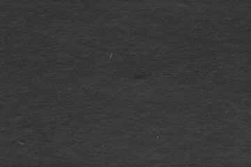 Cardboard black abstract texture close-up. Dark old paper background. Grunge concrete wall. Vintage blank wallpaper.