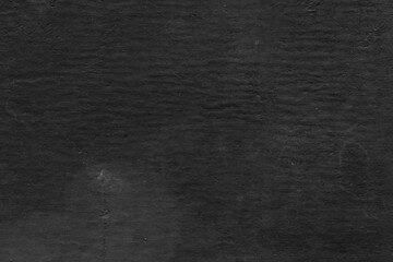 Cardboard black abstract texture close-up. Dark old paper background. Grunge concrete wall. Vintage blank wallpaper.