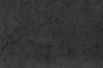 Cardboard black abstract texture close-up. Dark old paper background. Grunge concrete wall. Vintage blank wallpaper.