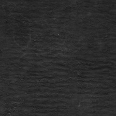 Cardboard black abstract texture close-up. Dark old paper background. Grunge concrete wall. Vintage blank wallpaper.