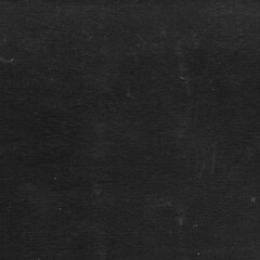 Cardboard black abstract texture close-up. Dark old paper background. Grunge concrete wall. Vintage blank wallpaper.