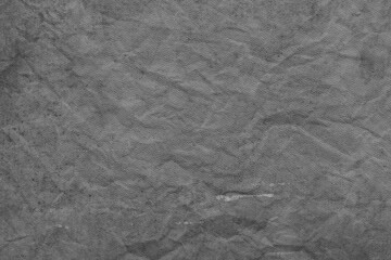 Cardboard black abstract texture close-up. Dark old paper background. Grunge concrete wall. Vintage blank wallpaper.
