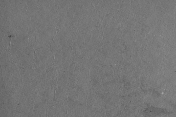 Cardboard black abstract texture close-up. Dark old paper background. Grunge concrete wall. Vintage blank wallpaper.