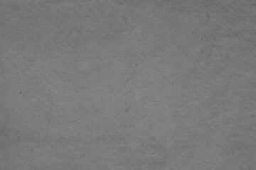 Cardboard black abstract texture close-up. Dark old paper background. Grunge concrete wall. Vintage blank wallpaper.