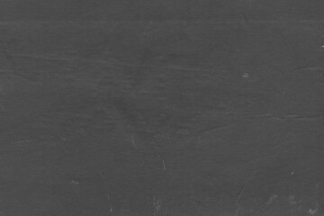 Cardboard black abstract texture close-up. Dark old paper background. Grunge concrete wall. Vintage blank wallpaper.