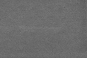 Cardboard black abstract texture close-up. Dark old paper background. Grunge concrete wall. Vintage blank wallpaper.
