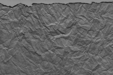 Cardboard black abstract texture close-up. Dark old paper background. Grunge concrete wall. Vintage blank wallpaper.