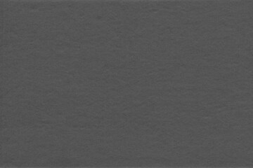 Cardboard black abstract texture close-up. Dark old paper background. Grunge concrete wall. Vintage blank wallpaper.