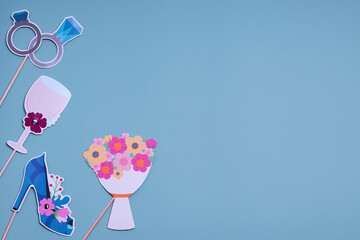 Postcard concept for Valentines, Womens Day, Mens Day, Wedding Day. Party accessories on a blue background. Flat lay, top view. Copy space.