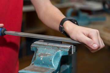 Craftsman Works With File Metal On Vise - Closeup