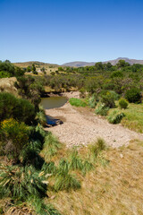 Beautiful landscape of low mountain ranges seen from the prairie during the southern summer.