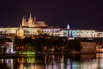 Fototapeta na wymiar Charles Bridge in Prague in the evening with colorful lights from lanterns