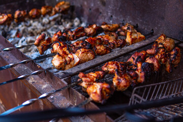 Fresh shish kebab on skewers is fried on the grill. Grilled meat on skewers.