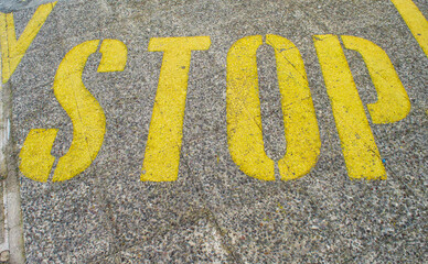 Stop sign painted on asphalt.
