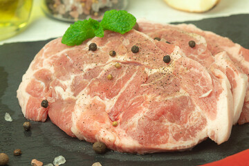 Raw pork steak on a cutting board with space for text