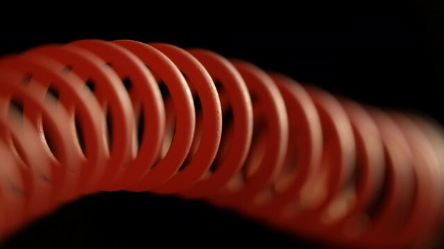 heating a spiral wire to red close-up on a dark background, abstraction, soft focus