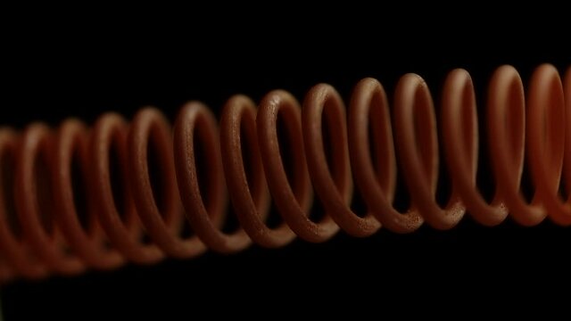 Red-hot spiral wire on a black background close-up. Macro, soft focus
