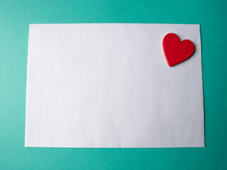 White paper and a red hearth on a green background