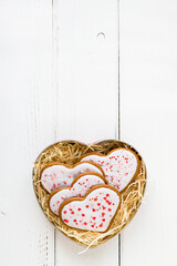 Valentine's day gift box with homemade heart shaped cookies on white background with copy space.
