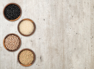 Assorted grains in wooden bowls with copy space