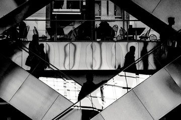 Abstract composition. The movement of people on a looped escalator - 403687083