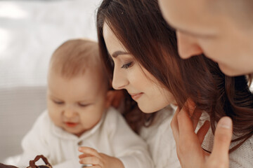 People preparing for Christmas. People sitting on the floor. Family is resting in a festive room.