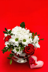 Fototapeta na wymiar Bouquet of fresh flowers and felt heart for Valentine's day or Wedding