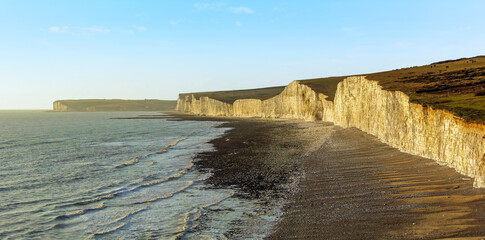 A view along the chalk cliffs of the Seven Sisters in Sussex UK at dusk