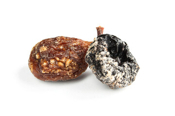 Dry rotten prune and sugared fig isolated on white background. Old moldy fruits close up