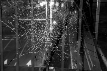 The broken window is spreading like a web of cracks - 403692227