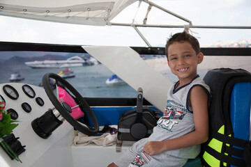 boy driving a sea boat