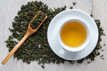 Top view brewed tea in a white cup, background.