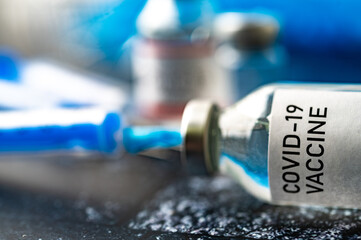 A single bottle vial of Covid-19 vaccine. Medical concept vaccination hypodermic injection...
