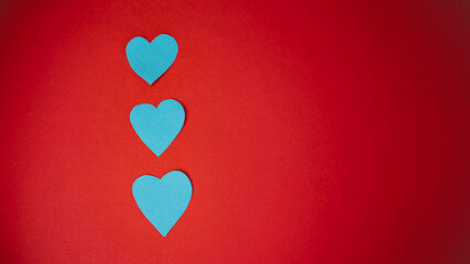 Valentine's Day. Blue hearts on a red background.