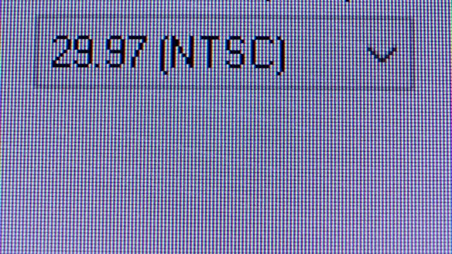 Macro shot of an old analog TV screen. Analogue retro TV settings menu in extreme close up. Selecting a television signal Pal or NTSC. Pixel background. Retro tv.