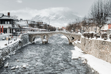 Arch bridge and Bistrica river at the old city of Prizren, Kosovo in winter season at morning
