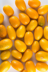 Top view of bunch of fresh kumquats in the organic food market. Some kumquats is cutted