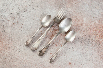 Antique metal cutlery on concrete background