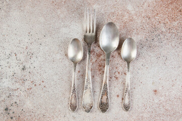 Antique metal cutlery on concrete background