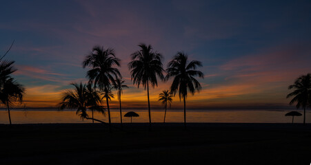 Fototapeta na wymiar Sunset over the beach and palm trees El Colony (ex Hilton) Isla de Juventud Cuba