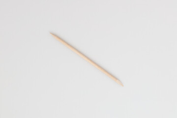 orange wood stick cosmetic tools for manicure and pedicure on a white background.